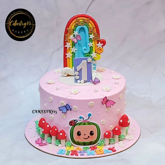 Eggless Cocomelon mushroom first birthday cake with rainbow topper and Black Forest layers, custom kids birthday cake in Noida