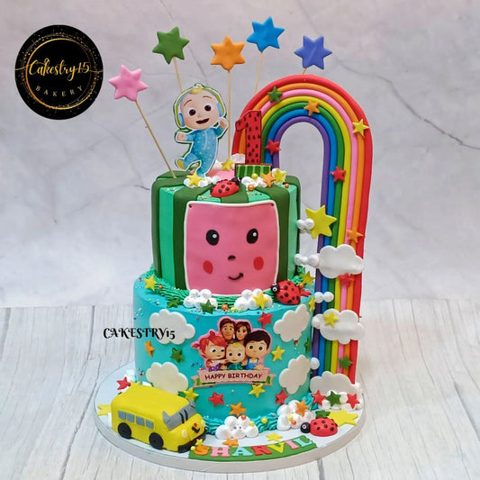 Eggless Cocomelon rainbow bus first birthday cake for kids in Noida with fondant characters and colourful theme design