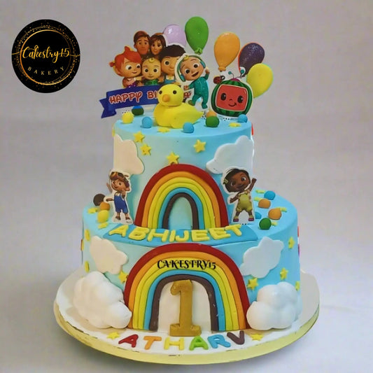 Eggless cocomelon rainbow twins kids birthday cake in Noida with fondant balloons stars and custom theme design