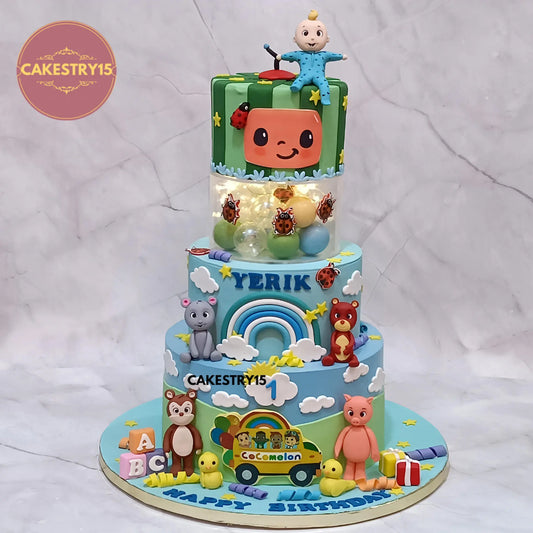 Cocomelon theme designer first birthday cake for Yerik 5kg eggless choco vanilla kids birthday cake in Noida with fondant characters and rainbow design