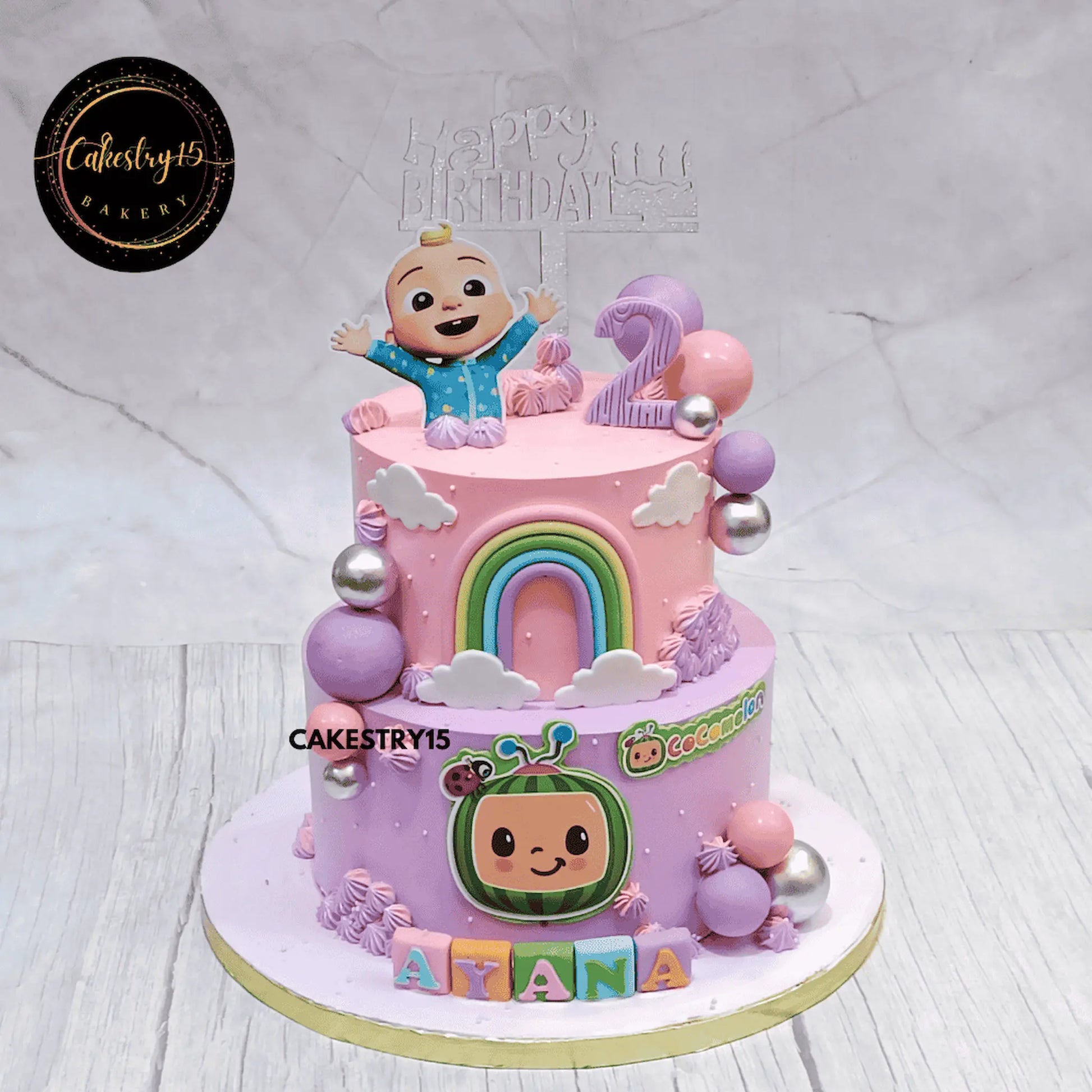 Eggless Cocomelon theme kids birthday cake for Ayana with rainbow and pastel design in Noida