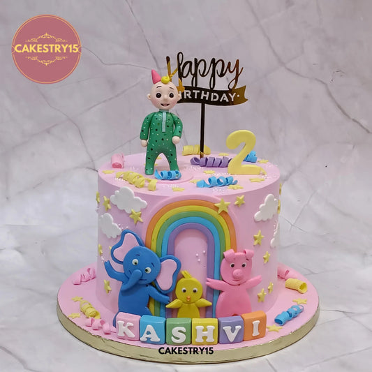 Cocomelon theme eggless kids birthday cake with fondant figurines and rainbow design in Noida by cakestry15