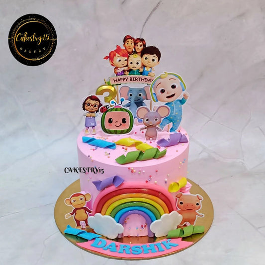 Cocomelon theme pink kids birthday cake with fondant characters, eggless butterscotch cake in Noida for custom kids celebrations
