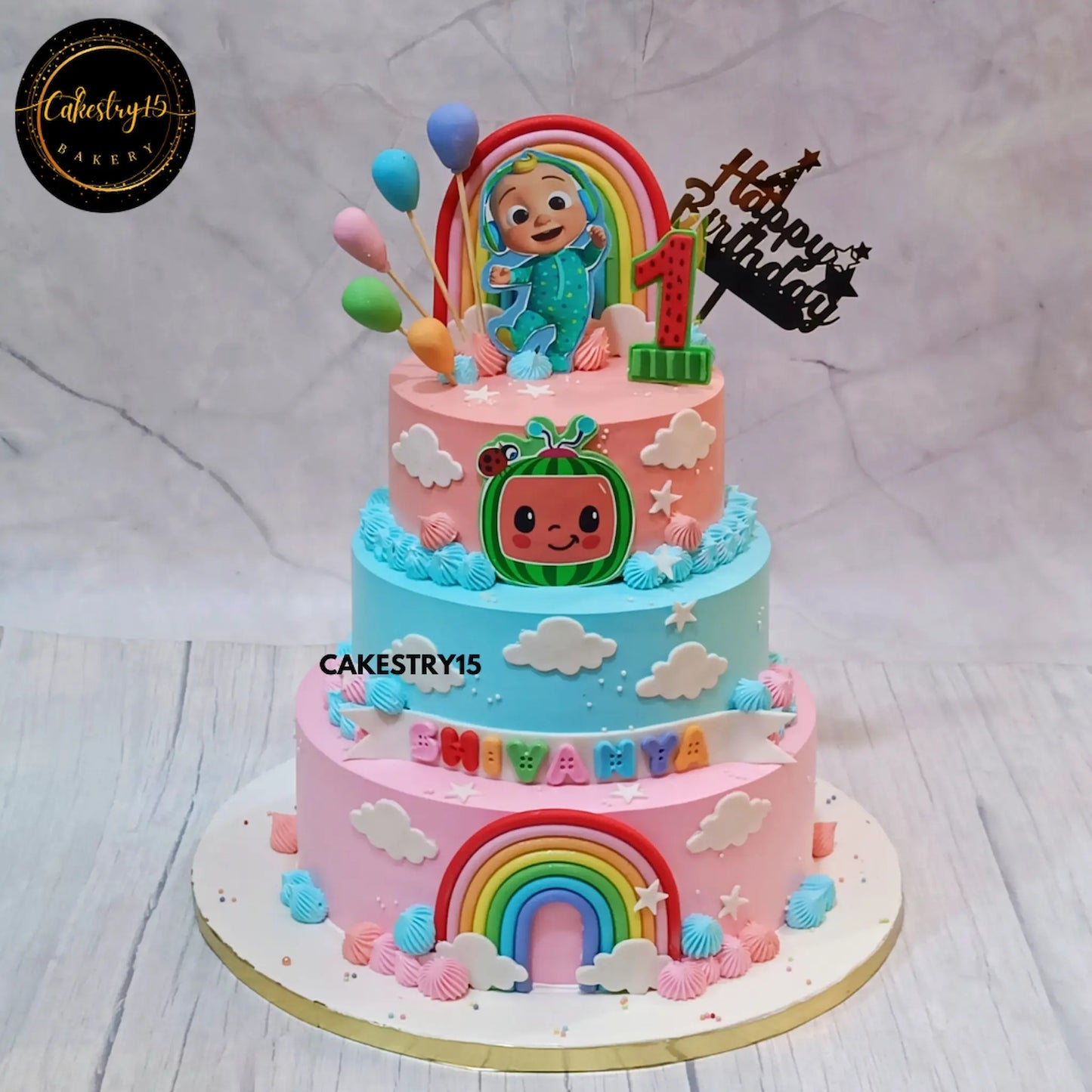 Cocomelon theme first birthday cake with rainbow balloons and stars, eggless custom kids birthday cake in Noida by Cakestry15
