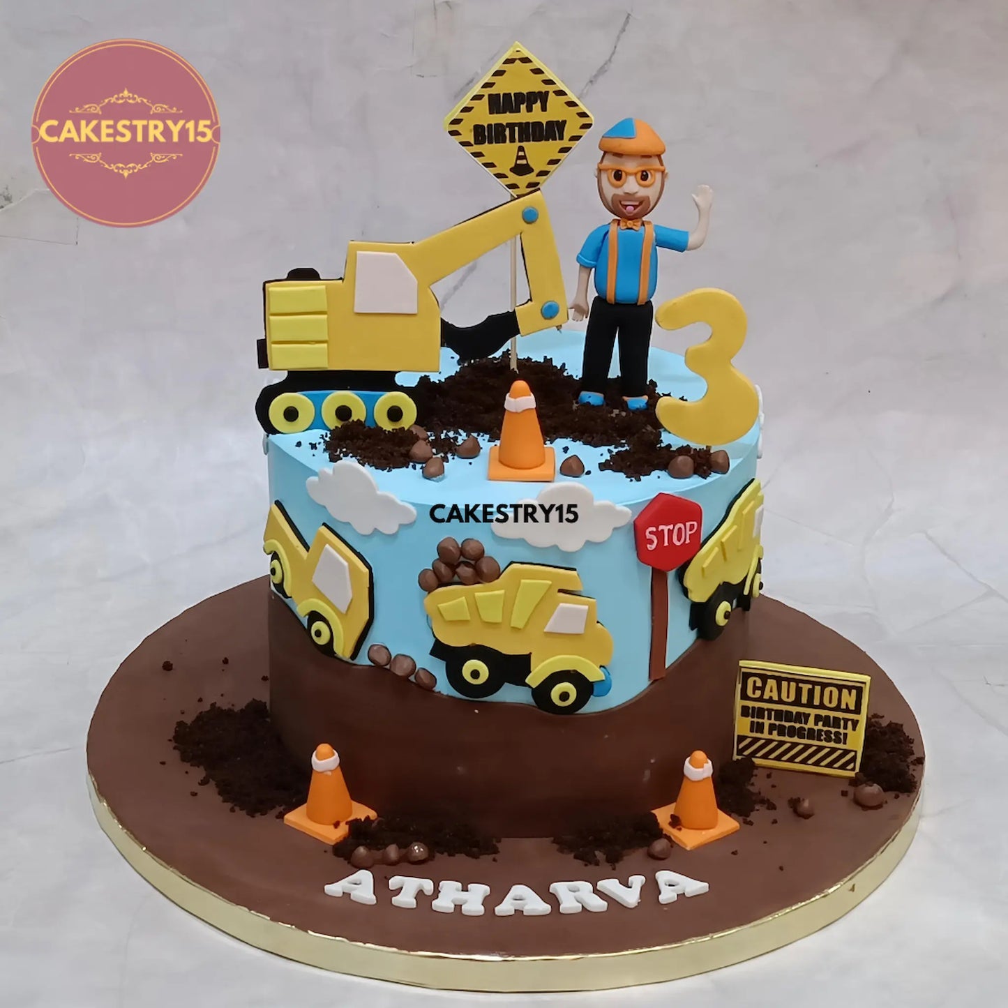 Eggless construction theme kids birthday cake with trucks and stone detailing, premium theme cake Noida for boys birthday celebrations.