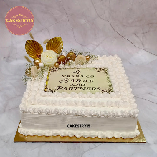 5kg chocolate corporate anniversary cake in square shape with macarons, roses, and decorative elements by cakestry15 in noida