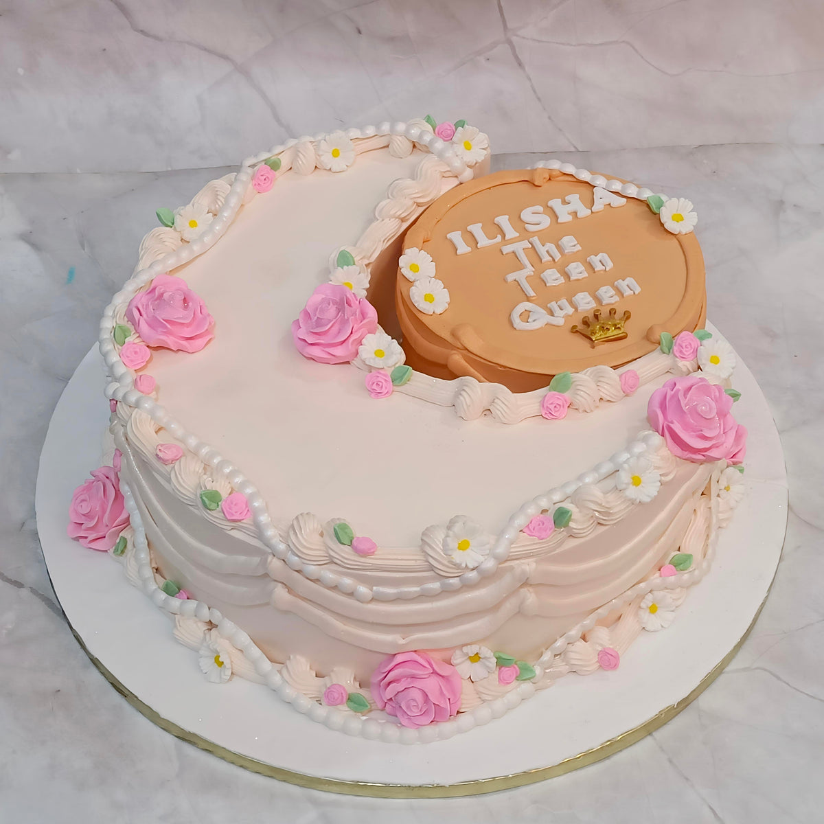 A stylish crescent theme kids birthday cake with ivory icing and fondant flowers from an eggless cakes bakery offering a theme cake 