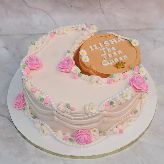 A stylish crescent theme kids birthday cake with ivory icing and fondant flowers from an eggless cakes bakery offering a theme cake 