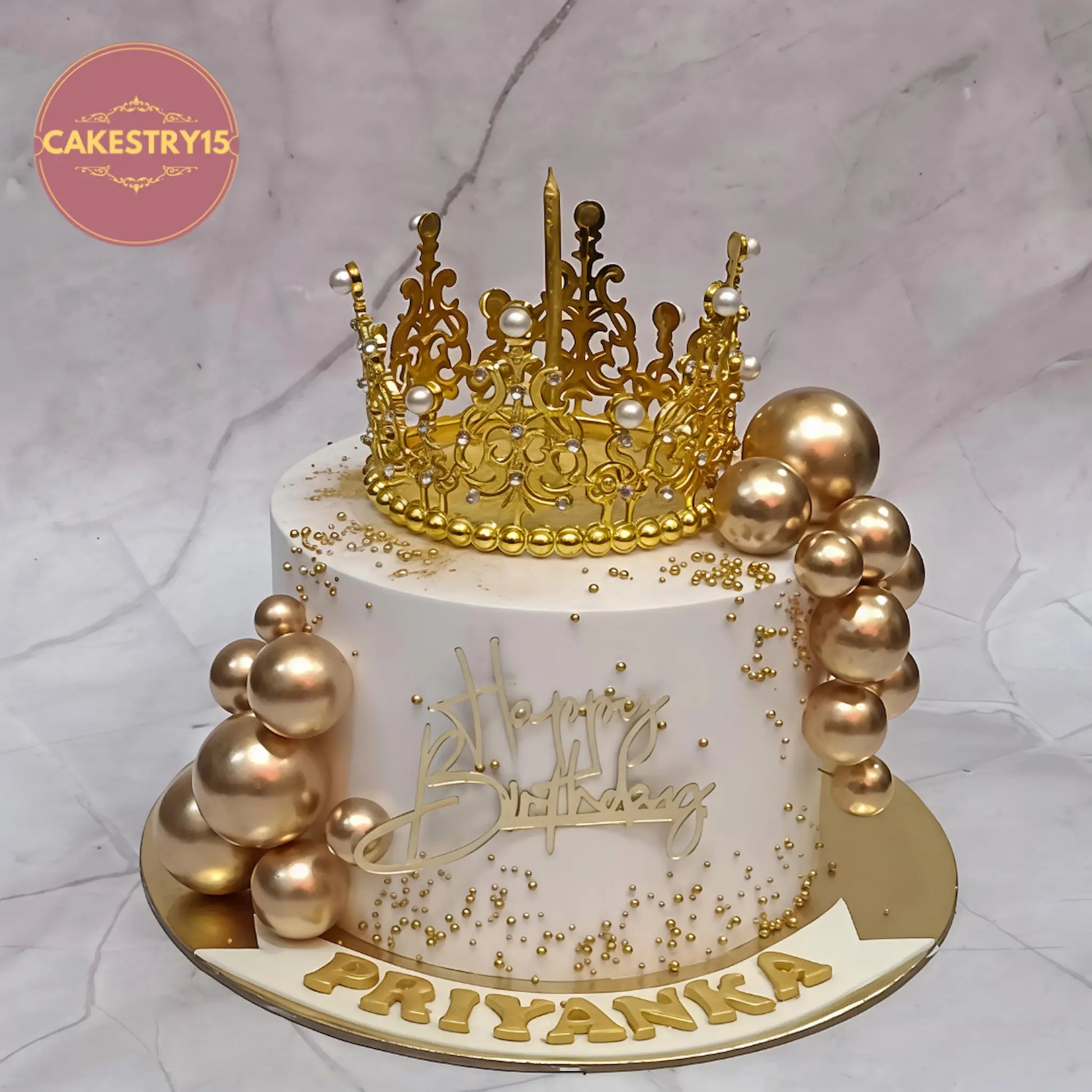 Crown theme eggless butterscotch birthday cake for 25th celebration with golden balls and custom name by Cakestry15 Noida