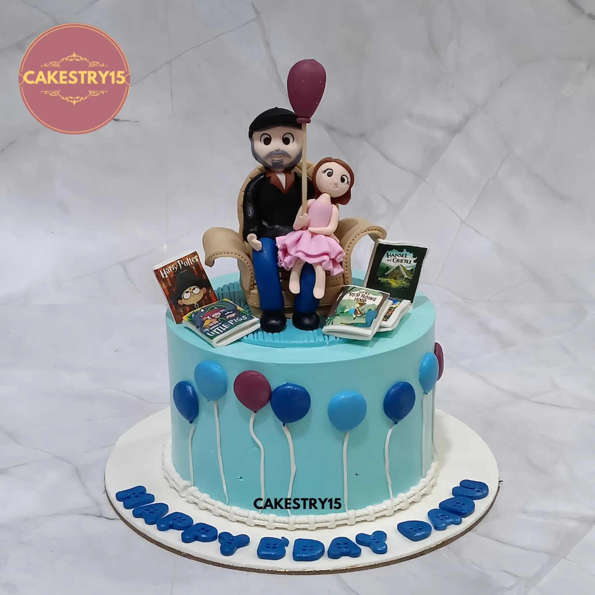 1kg eggless chocolate birthday cake featuring dad figurine with baby and fondant balloons from Cakestry15 Noida