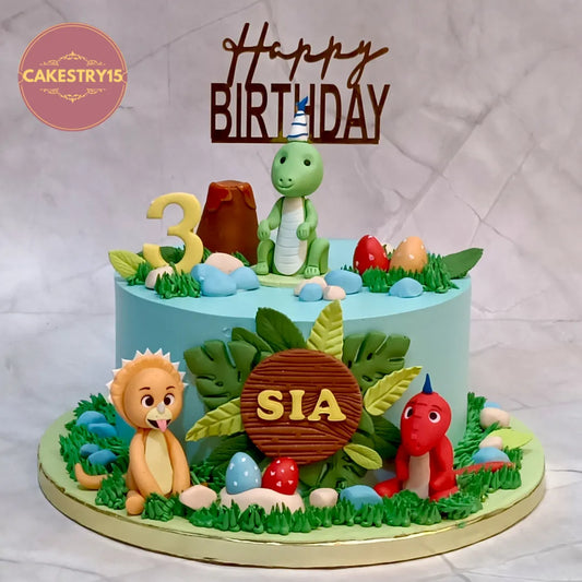 Eggless dino jungle theme kids birthday cake with fondant dinosaurs for 3rd birthday celebration in Noida.
