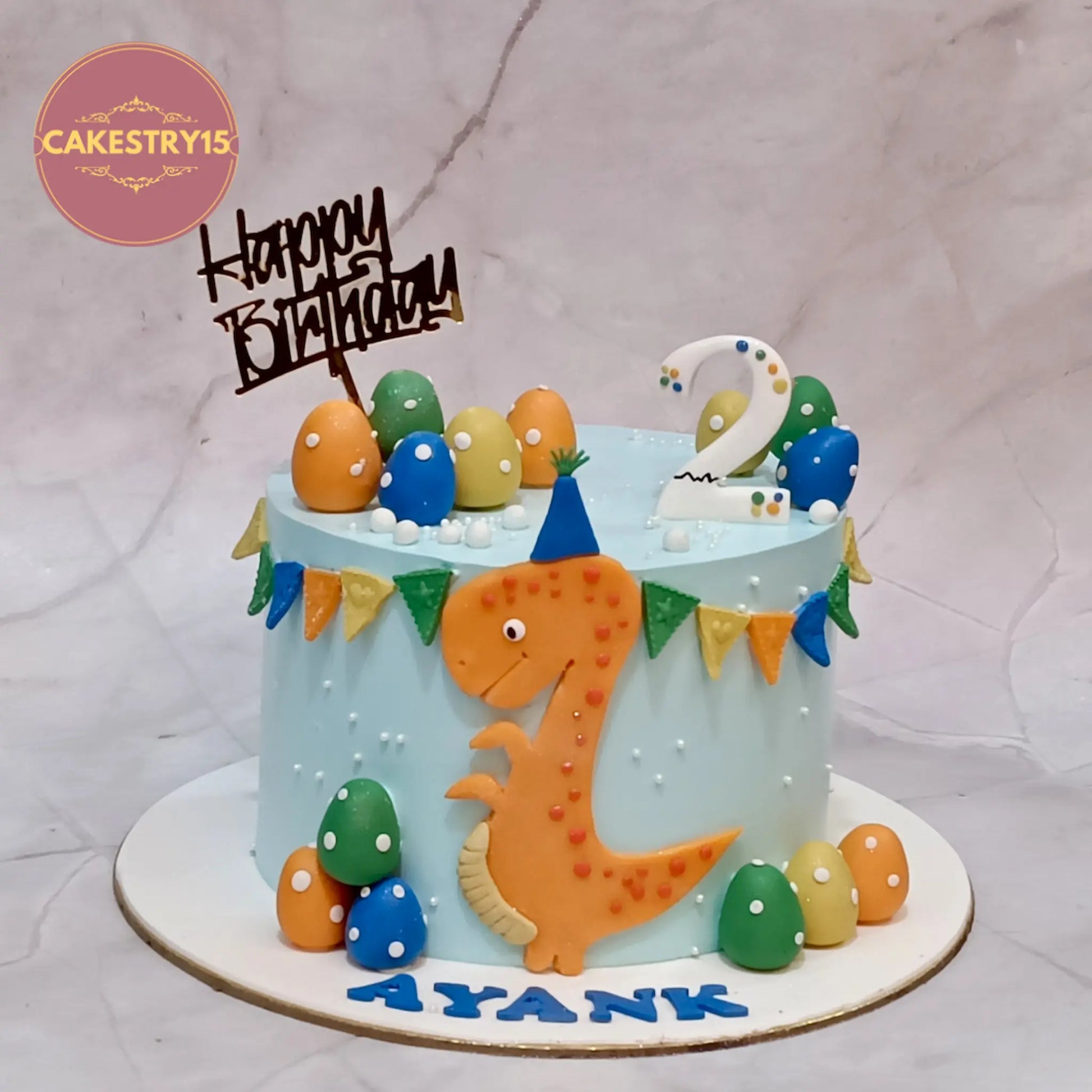 Dino theme kids birthday cake in Noida featuring eggless cakes with blueberry flavour and custom design