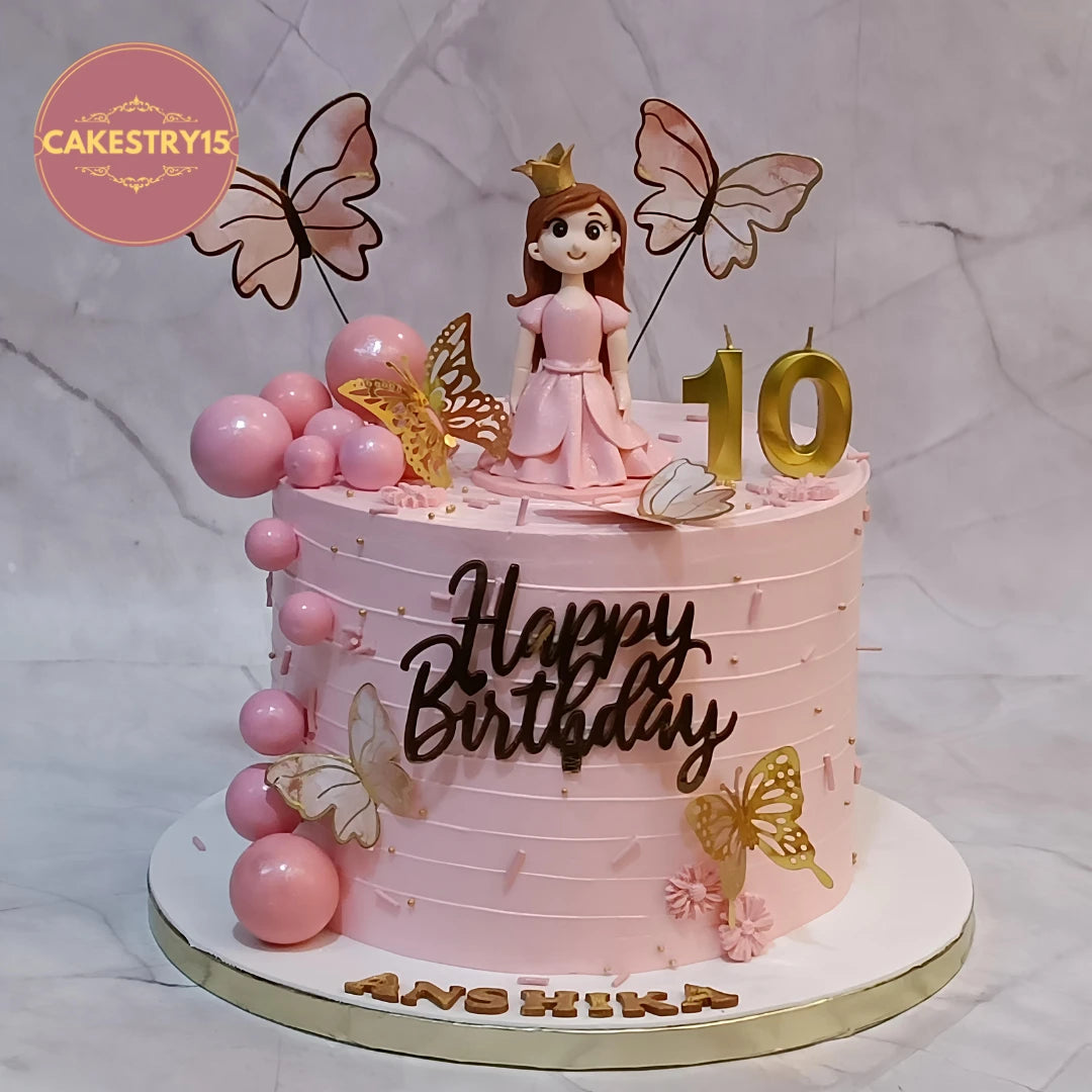 Doll princess crown kids birthday cake with butterflies and figurine, a premium theme cake Noida families choose from our collection of eggless cakes.