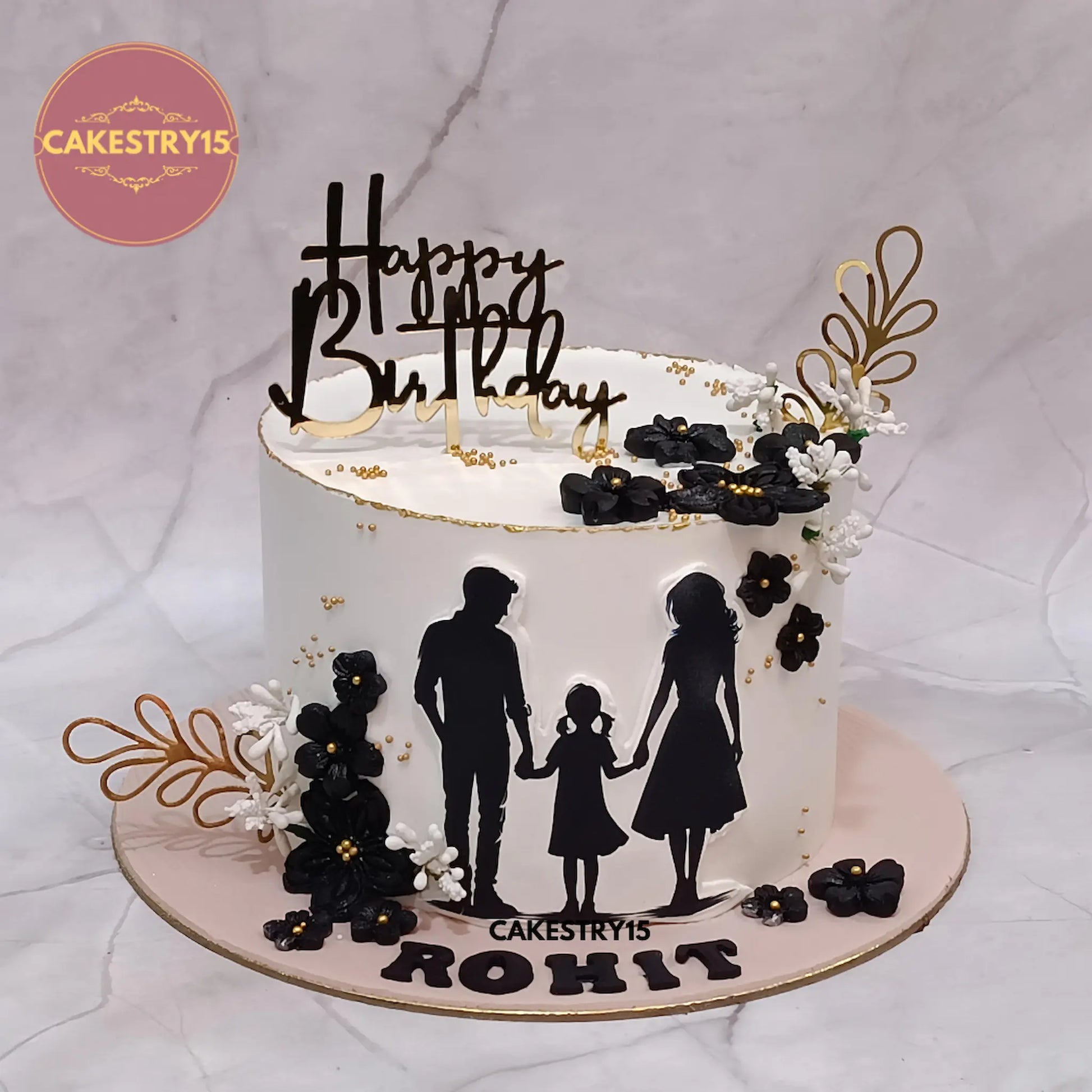 1kg eggless butterscotch birthday cake with edible family photo, black flowers, and golden ferns from Cakestry15 Noida