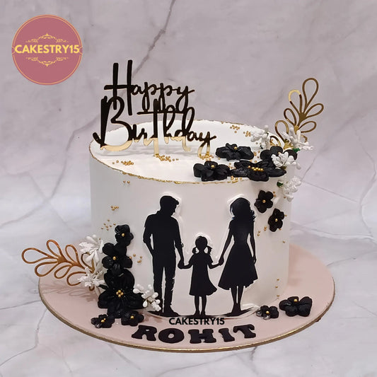 1kg eggless butterscotch birthday cake with edible family photo, black flowers, and golden ferns from Cakestry15 Noida