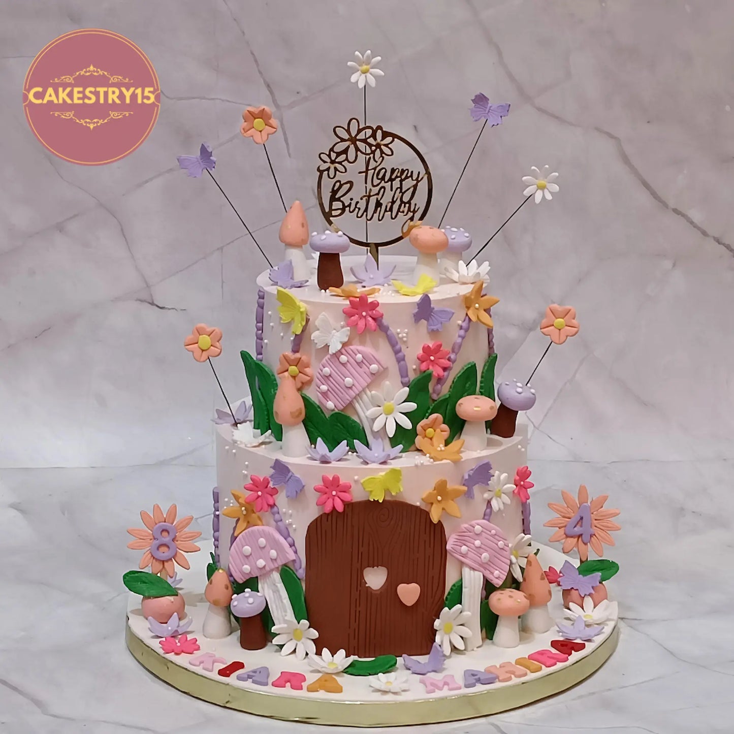 Enchanted forest theme kids birthday cake with mushrooms, butterflies and flowers, eggless pineapple cake in Noida for custom celebrations
