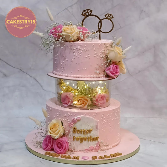 Elegant eggless cakes engagement design with fresh roses and lights, perfect as a theme cake Noida celebration cake.