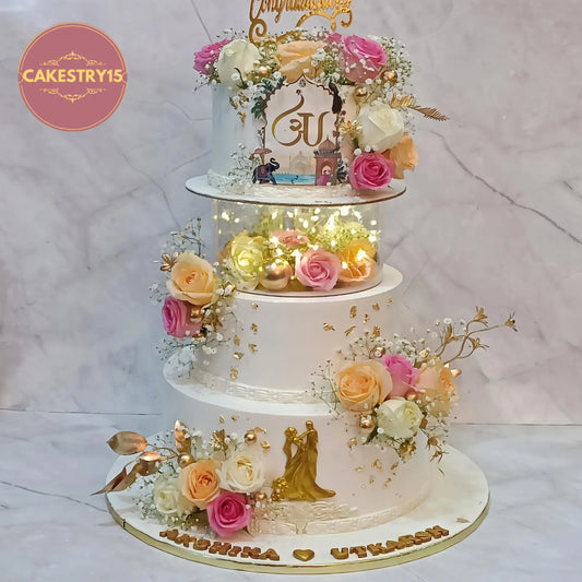 Elegant floral engagement cake with fresh roses, lights and fondant couple figurine, eggless chocolate theme cake in Noida