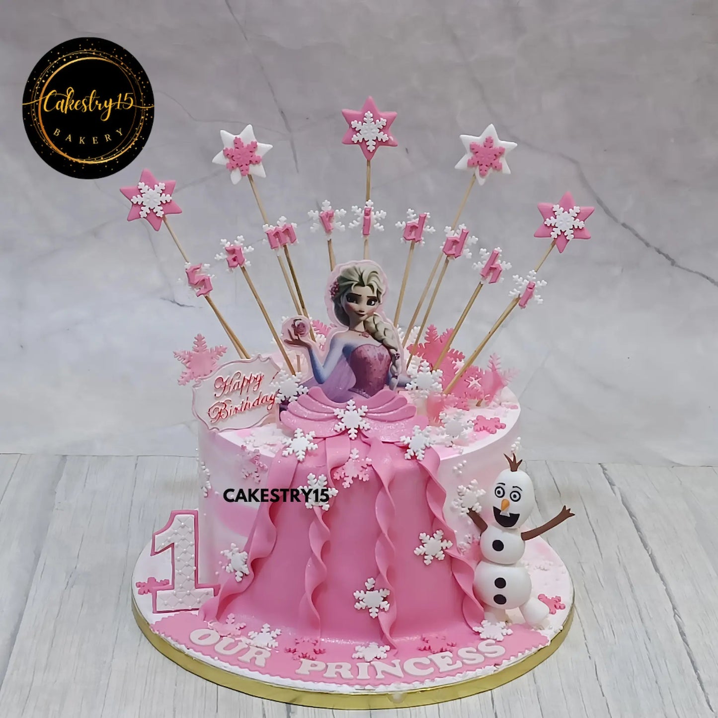 Frozen Frosty 1.5kg butterscotch first birthday Cake for samriddhi  in pink colour by cakestry15,noida,cake full image