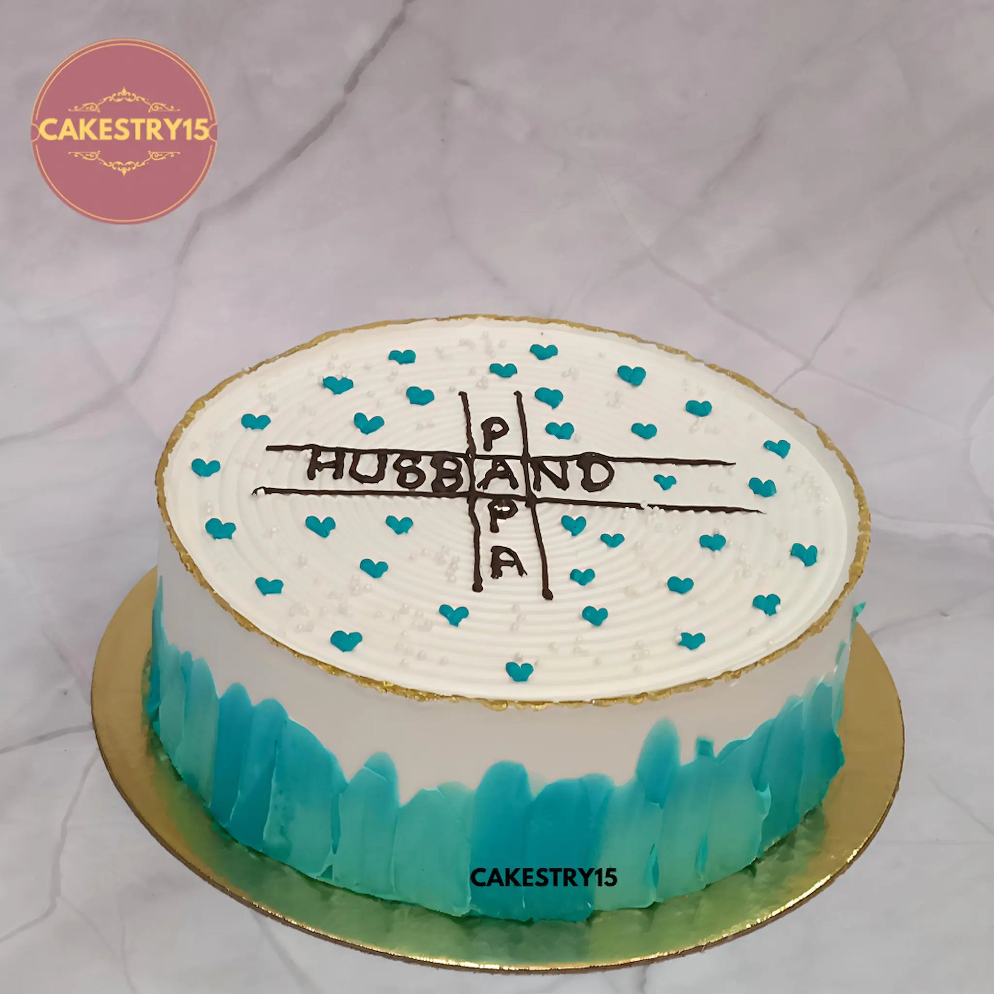 1kg eggless butterscotch cake with Papa and Husband text, golden rim, teal hearts from Cakestry15