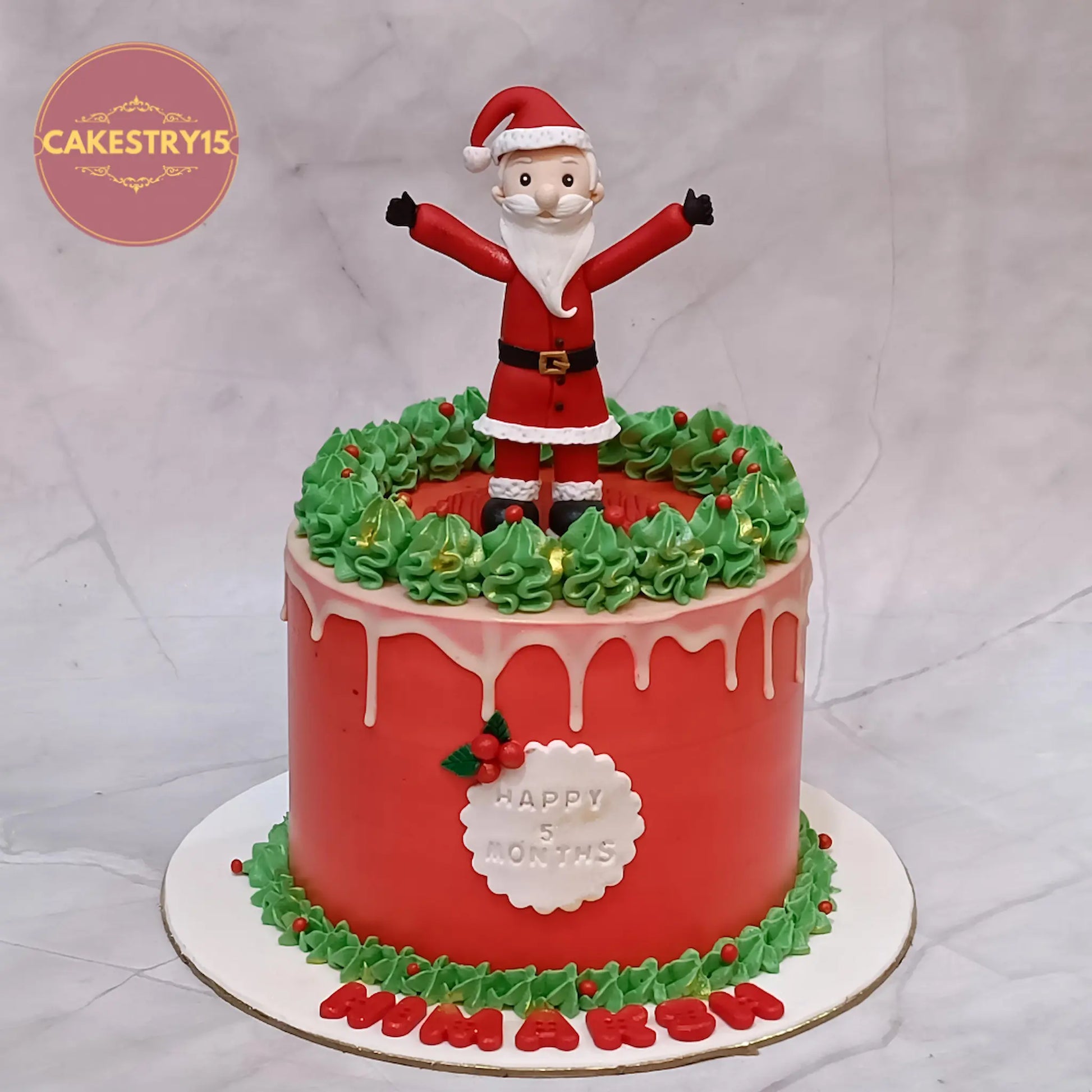 Halfway to one theme eggless chocolate cake for 5 months baby celebration with Santa fondant and festive red green icing in Noida by cakestry15