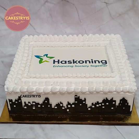 Eggless Haskoning theme corporate anniversary chocolate cake with fondant building design and edible company logo in Noida