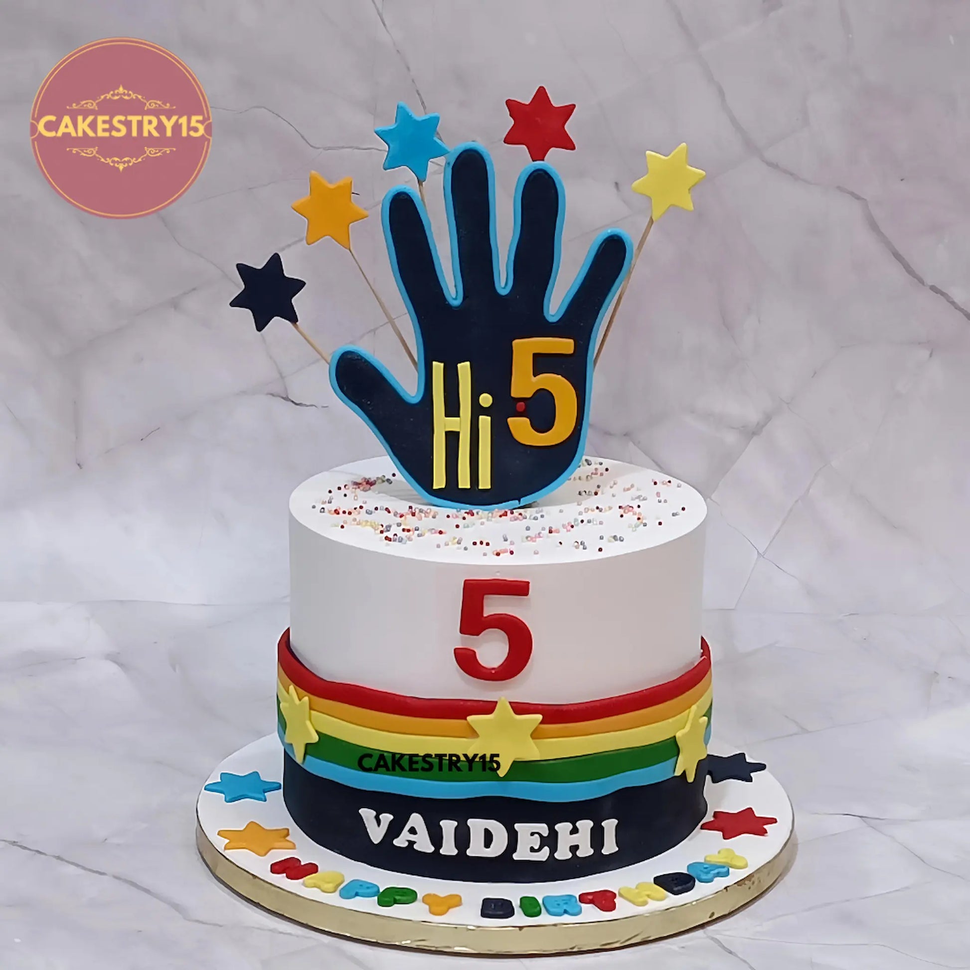Eggless Hi5 kids birthday cake with colourful fondant strips and stars, premium theme cake Noida for birthday celebrations.