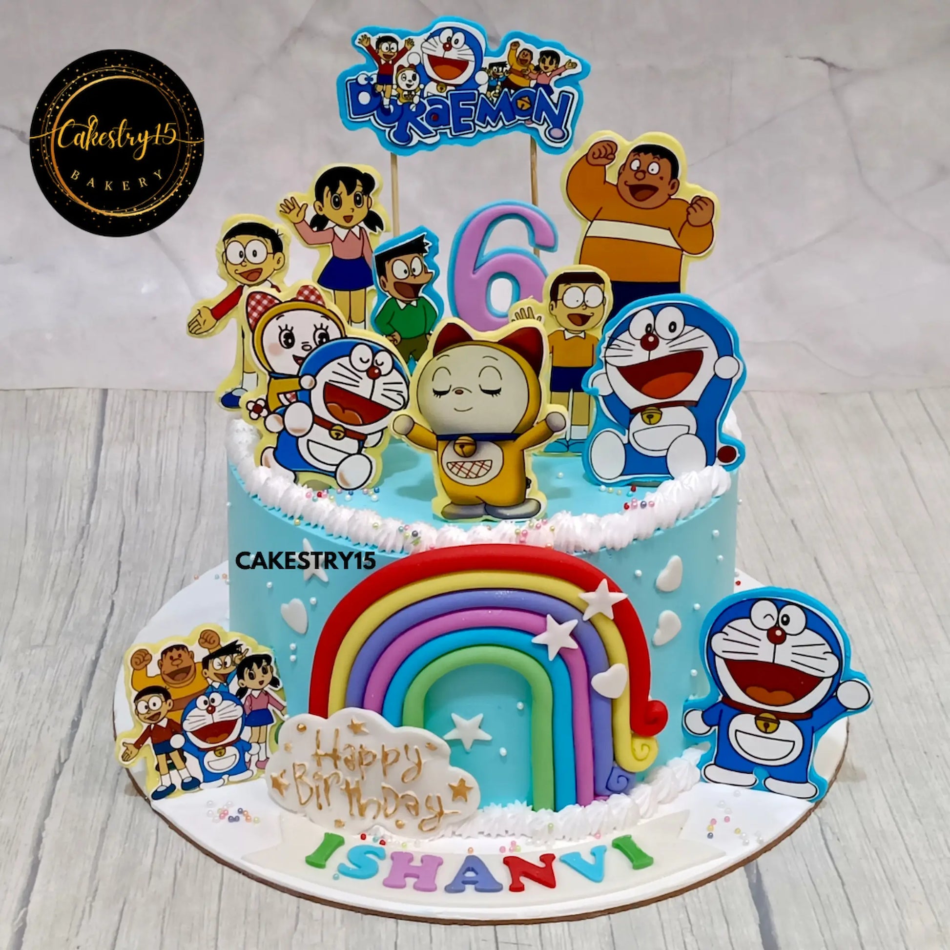 1.5kg blueberry Doraemon birthday cake for Ishanvi with edible character images and rainbow