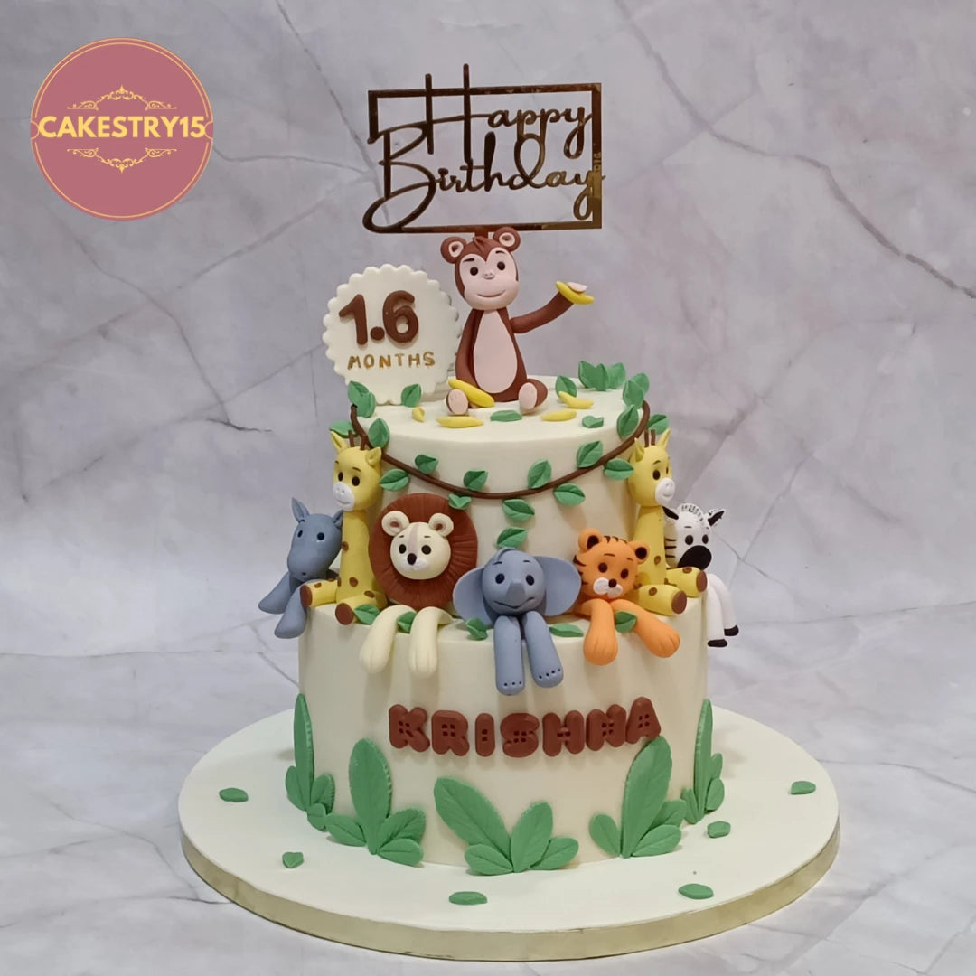 Premium eggless jungle animals kids birthday cake featuring elephant, giraffe, lion, tiger, rhino and monkey figurines, handcrafted as a custom theme cake in Noida.