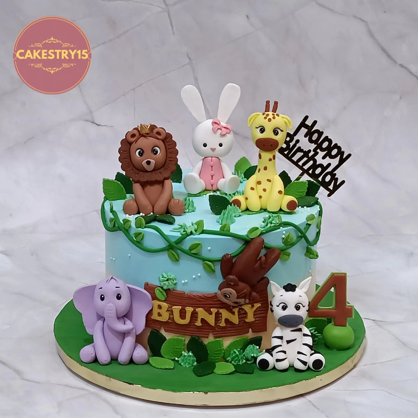 Jungle bunny 4th birthday cake in chocolate flavour with fondant animals, eggless kids birthday cake by Cakestry15 Noida