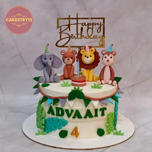 A custom jungle-themed 4th birthday cake with animal figurines (elephant, bear, lion, monkey) and a 'Happy Birthday' topper, decorated with green leaf accents and the name 'ADVAAIT'.
