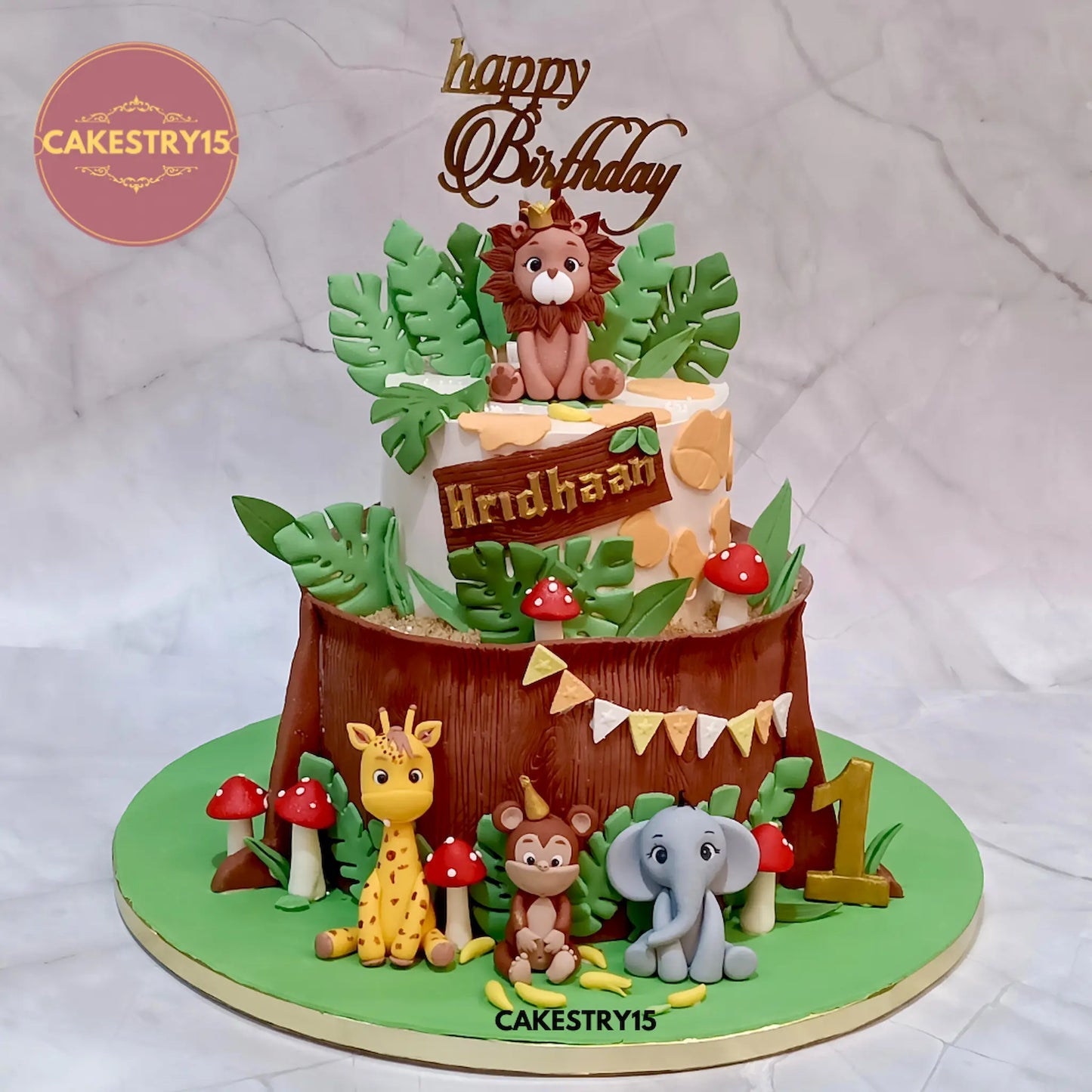 eggless jungle theme 4kg choco vanilla birthday cake with lion, giraffe, monkey, elephant, mushrooms and fondant bark from Cakestry15 Noida