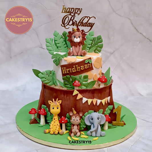 eggless jungle theme 4kg choco vanilla birthday cake with lion, giraffe, monkey, elephant, mushrooms and fondant bark from Cakestry15 Noida