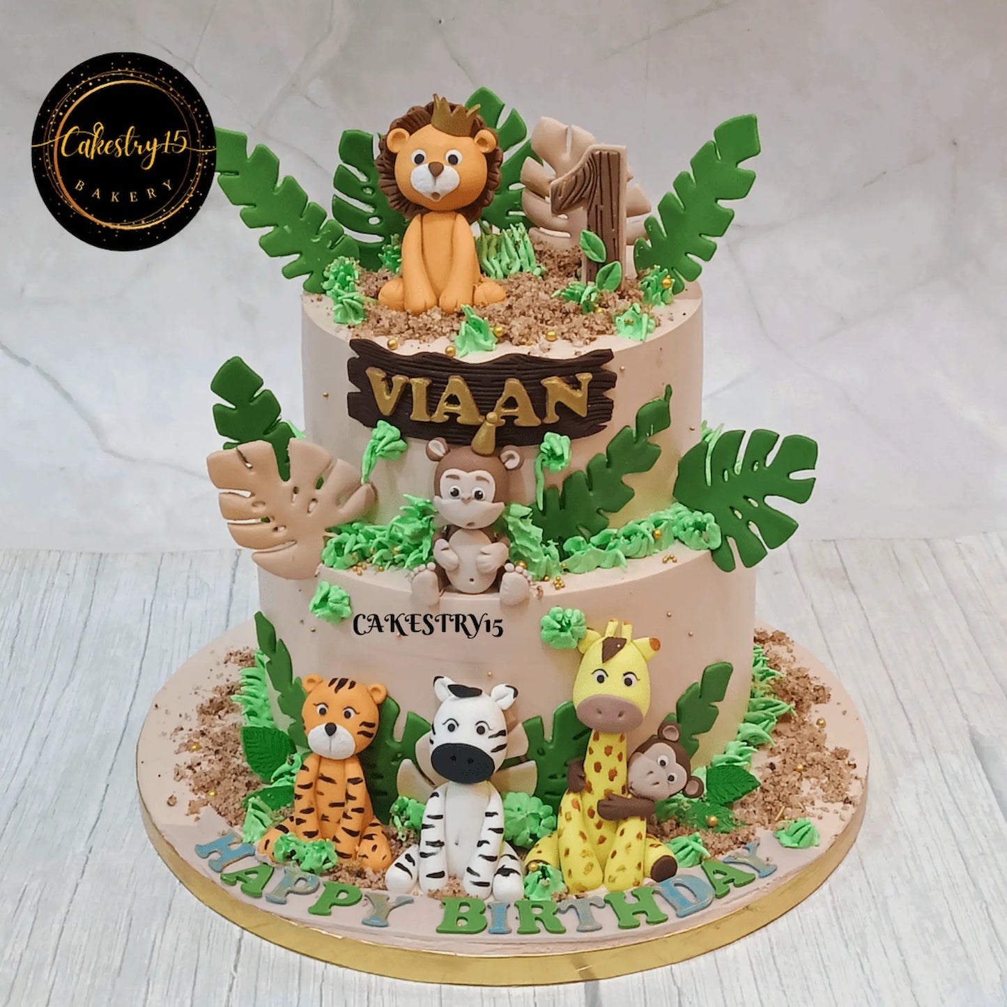 Eggless jungle kids birthday cake with fondant safari animals for first birthday celebration and theme cake Noida delivery.