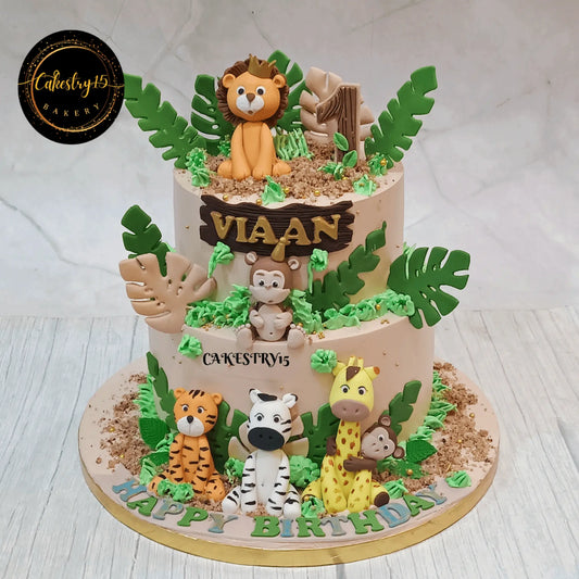 Eggless jungle kids birthday cake with fondant safari animals for first birthday celebration and theme cake Noida delivery.