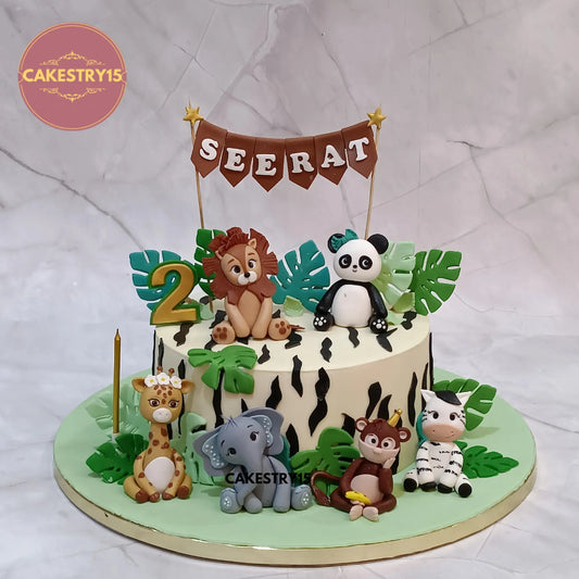 Eggless jungle theme kids birthday cake with fondant safari animals and chocolate vanilla layers for theme cake Noida delivery.