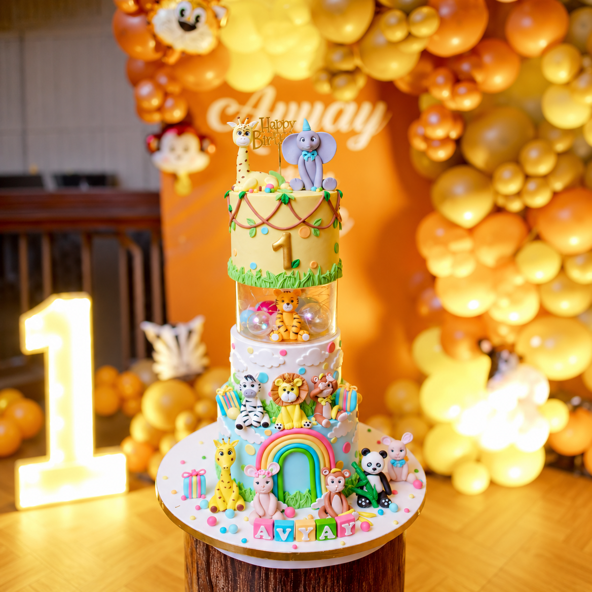 Jungle theme first birthday cake with fondant jungle animals displayed at the celebration venue.