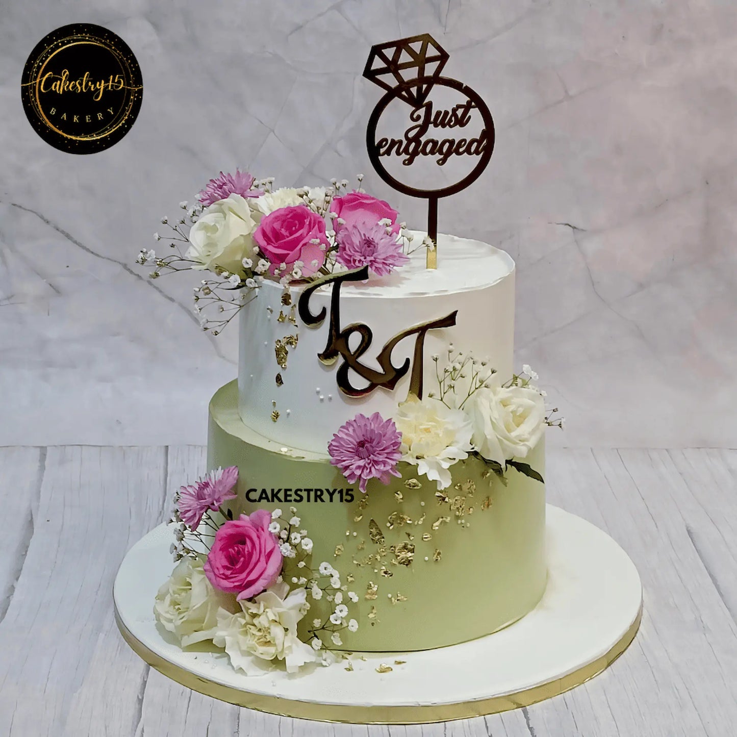5kg two-tier Just Engaged cake with Black Forest and Butterscotch flavours, decorated with ivory and pink carnations, roses, and baby’s breath by cakestry15 noida