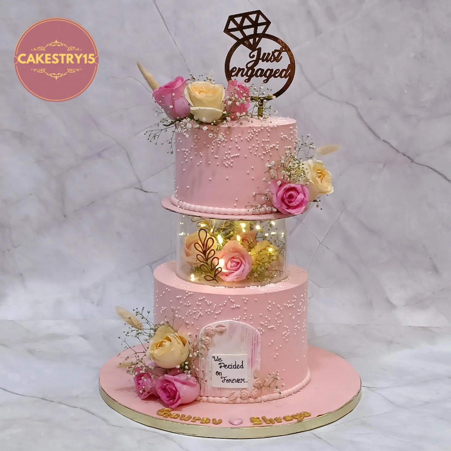 Eggless just engaged floral cake with roses, pearls and lights by Cakestry15 in Noida