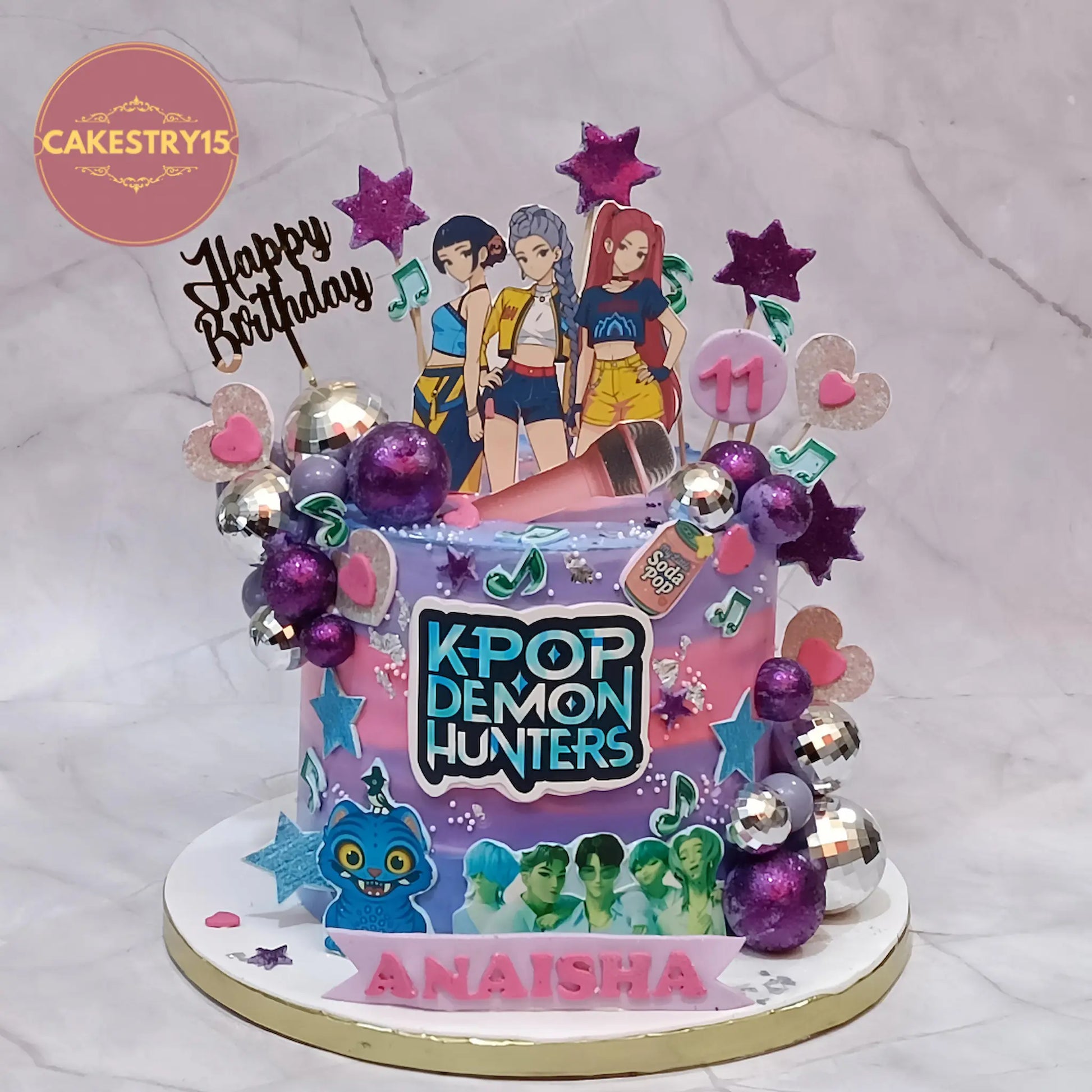 Eggless K-Pop demon hunters theme birthday cake in Noida with edible K-Pop images, pink lavender icing and musical decorations for kids birthday by cakestry15