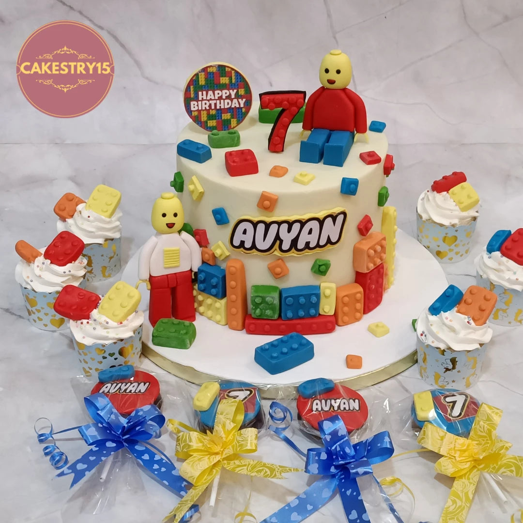 Lego birthday cake with matching cupcakes and chocolate discs.