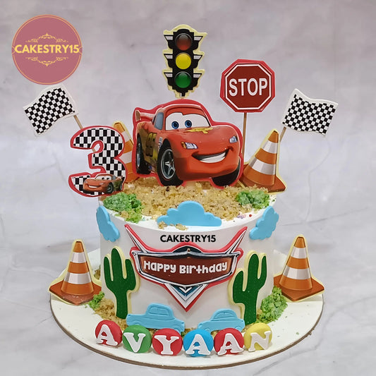 Eggless Lightning McQueen theme kids birthday cake with choco vanilla flavour and racing design by Cakestry15 in Noida