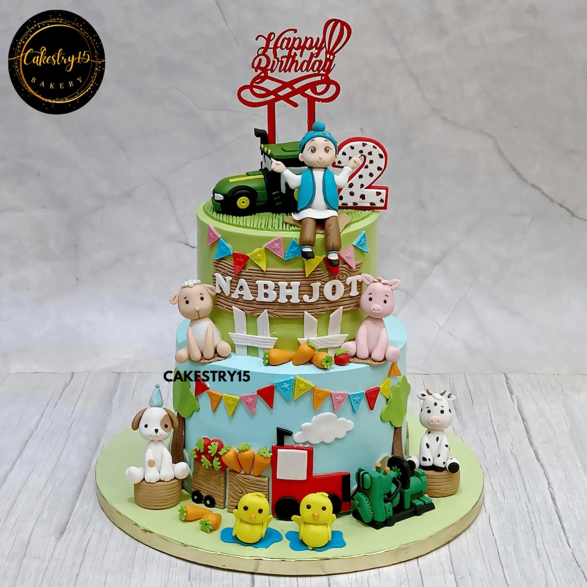 2-tier farm theme birthday cake with tractor, animals, and surdy boy figurine by cakestry15 noida