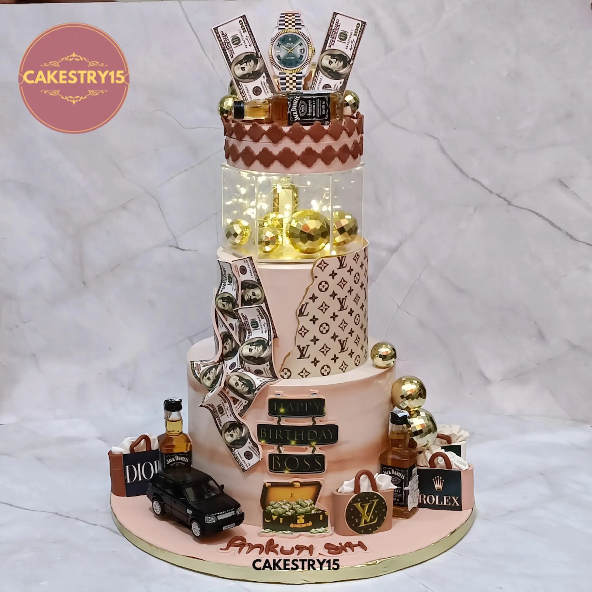 5kg luxury boss chocolate birthday cake with Louis Vuitton, dollar bills, Jack Daniel’s bottles, and rotating LED display from Cakestry15 Noida