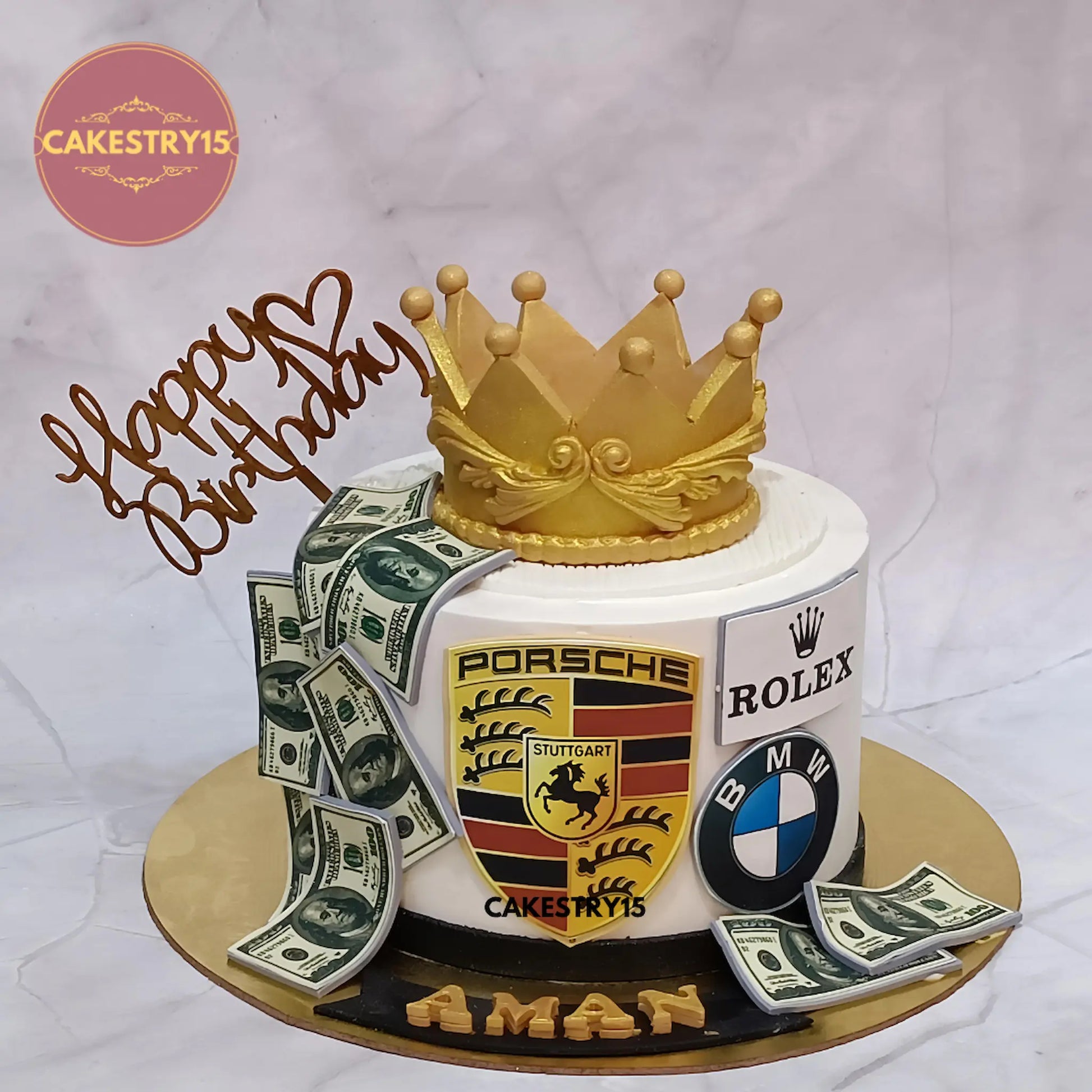 Luxury black forest birthday cake with crown, Porsche, BMW, Rolex logos from Cakestry15 Noida