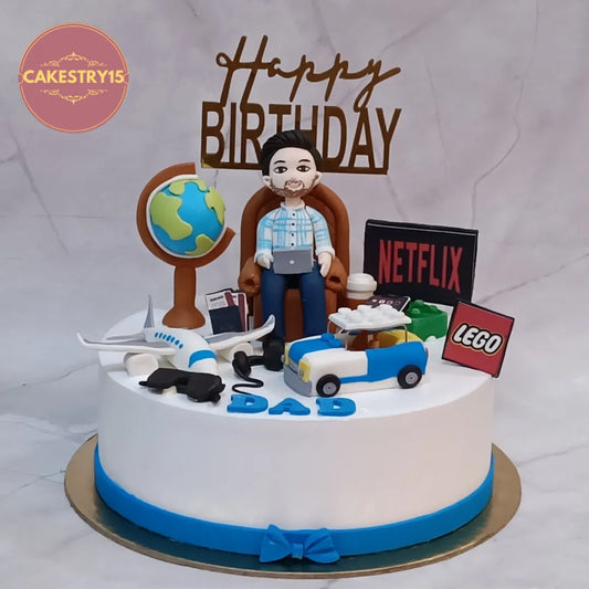 Luxury eggless cakes featuring globe, airplane and sofa figurine details for a premium theme cake Noida birthday celebration.