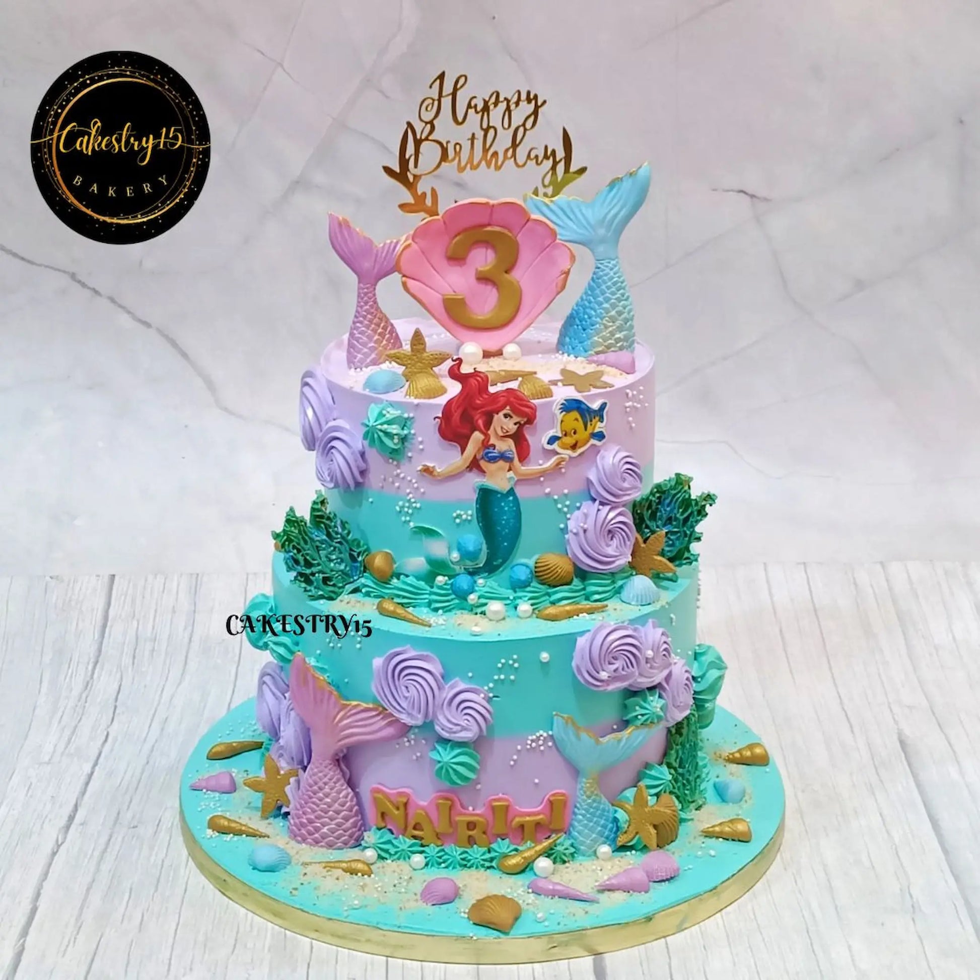 Mermaid Enchanted kids birthday cake with mermaid illustrations, fondant tails and coral accents, featuring eggless cakes from a theme cake Noida bakery.