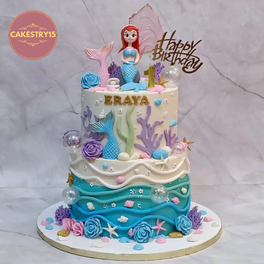 Elegant eggless mermaid theme kids birthday cake in Noida with fondant mermaid and ocean-inspired decorations for a first birthday celebration.