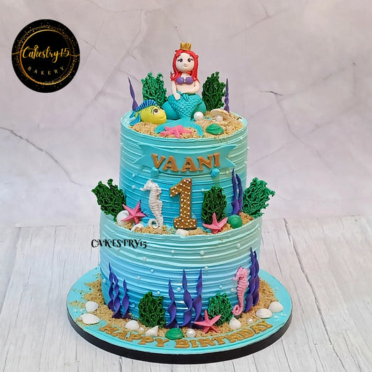 Mermaid princess kids birthday cake with 3D fondant mermaid design from an eggless cakes bakery offering a theme cake Noida.