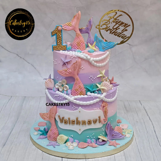 Mermaid theme kids birthday cake with fishtails and coral details from an eggless cakes bakery offering a theme cake Noida.